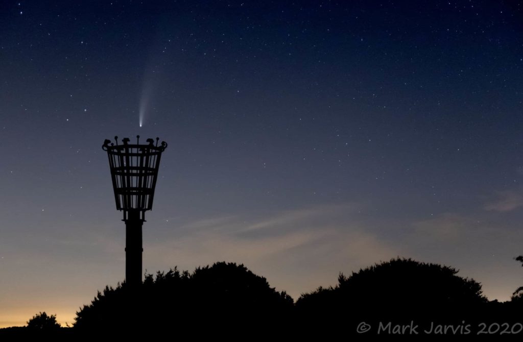 Photo showing comet in sky above the beacon