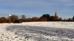 Snowy field showing beacon in background